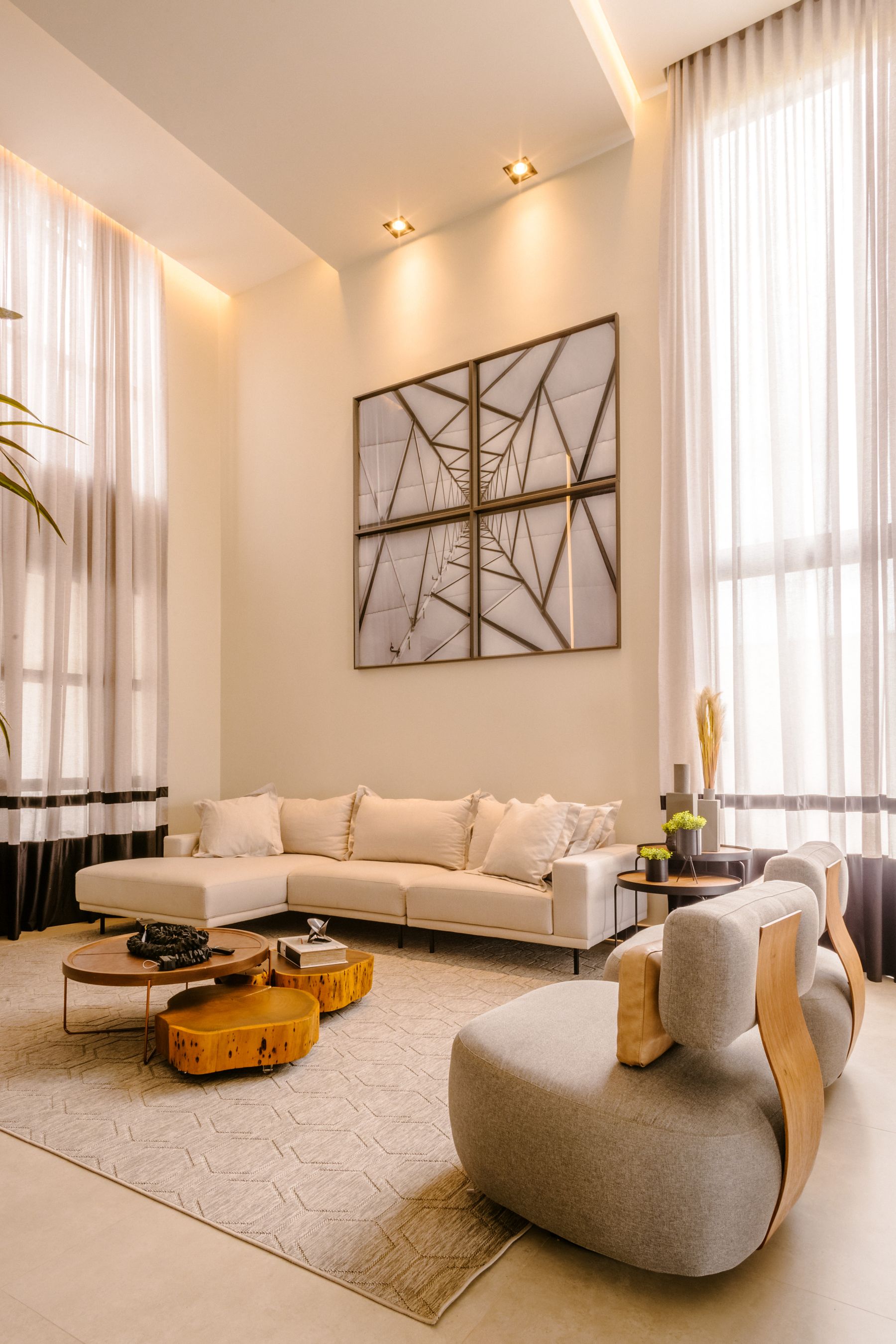 Illustrative modern living room with tall windows and neutral furnishings